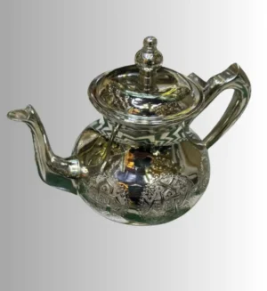 Moroccan silver teapot Traditional tea set Moroccan tea culture Silver teapot design Handcrafted silverware Moroccan decor Artisan teapots Vintage silver teapot Decorative tea accessories Moroccan tea ceremony